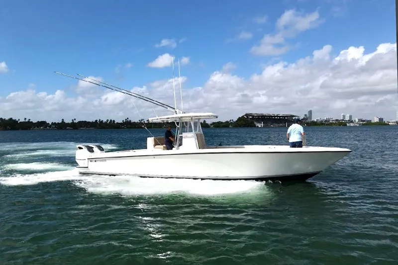 Slide: The Image of 2008 Contender 36 Open boat cruising on a sunny day with two people onboard. - 79