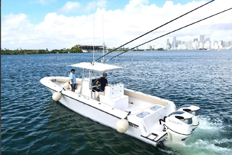 Slide: The Image of 2008 Contender 36 Open boat cruising on water with city skyline in background. - 81