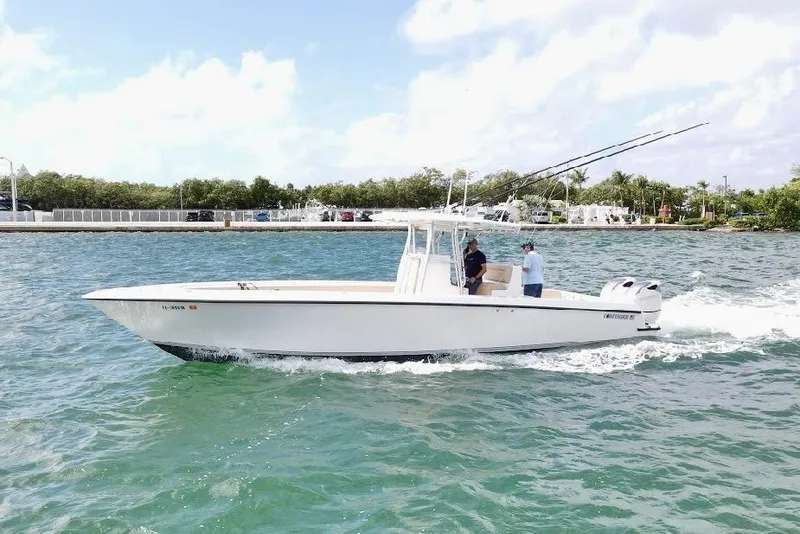 Slide: The Image of 2008 Contender 36 Open boat cruising on clear blue water, two people onboard. - 85