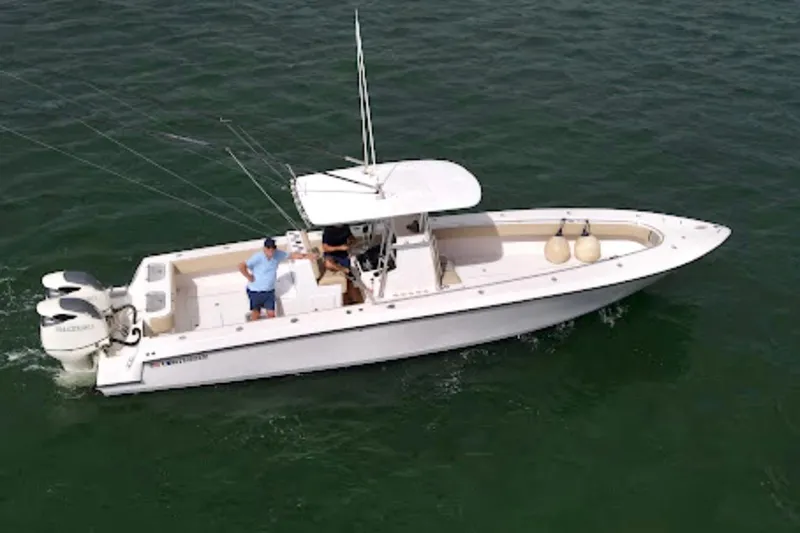 Slide: The Image of 2008 Contender 36 Open boat on water with two people onboard. - 86