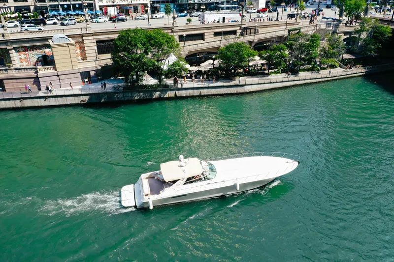 Slide: The Image of 1997 Sea Ray 630 Super Sun Sport yacht cruising on a scenic river. - 21