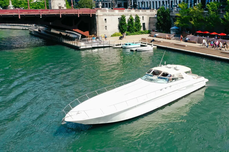 Slide: The Image of 1997 Sea Ray 630 Super Sun Sport yacht cruising on a scenic river near a bridge. - 22