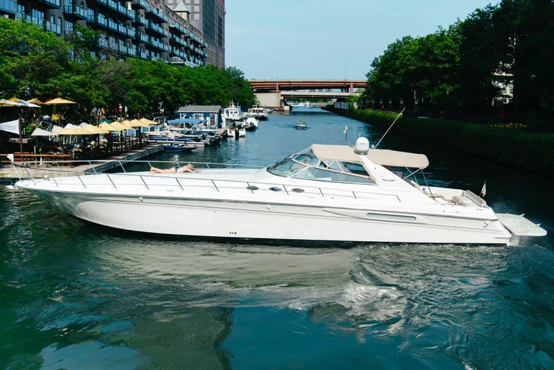 Slide: The Image of 1997 Sea Ray 630 Super Sun Sport yacht cruising in a scenic canal. - 27
