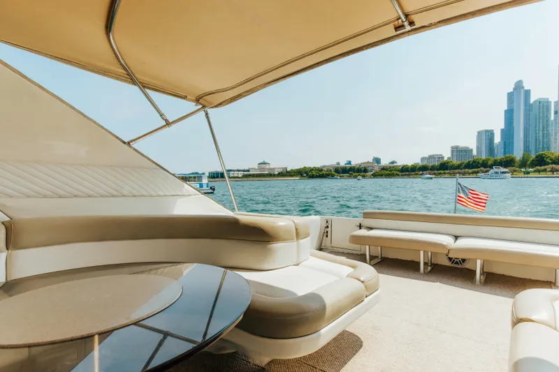 Slide: The Image of Luxurious 1997 Sea Ray 630 Super Sun Sport yacht with city skyline and waterfront view. - 37