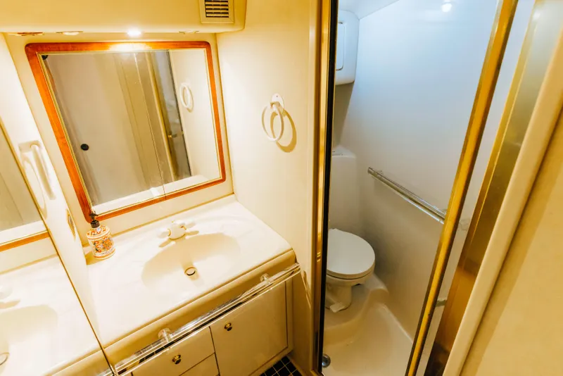 Slide: The Image of Bathroom interior of 1997 Sea Ray 630 Super Sun Sport yacht, featuring sink and toilet. - 42