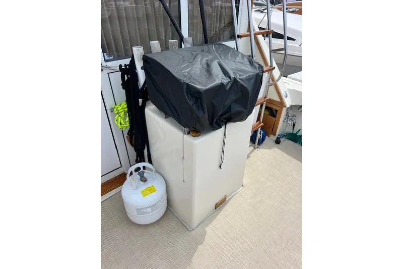 Slide: The Image of 1981 Viking 35 Convertible boat deck with covered equipment and propane tank. - 11