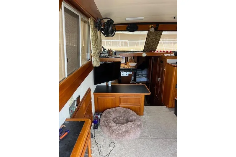 Slide: The Image of Interior of 1981 Viking 35 Convertible boat with cozy seating and wooden cabinetry. - 13