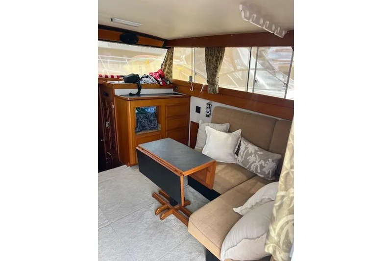 Slide: The Image of Interior of 1981 Viking 35 Convertible boat with cozy seating and wooden table. - 14