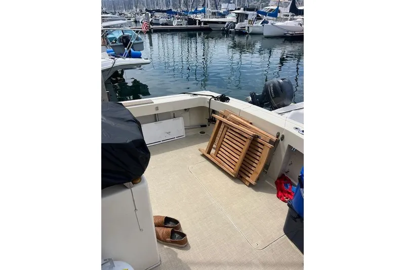 Slide: The Image of 1981 Viking 35 Convertible boat deck with folded chairs, docked in marina. - 15