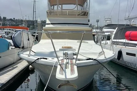 Slide: The Image of 1981 Viking 35 Convertible yacht docked with surfboard on deck. - 2