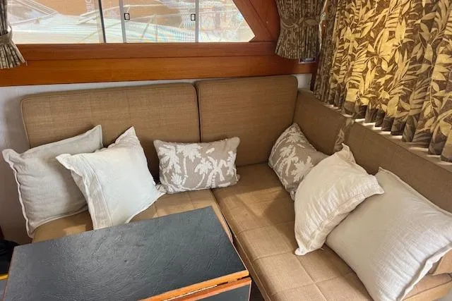 Slide: The Image of 1981 Viking 35 Convertible interior with beige cushions and patterned curtains. - 20