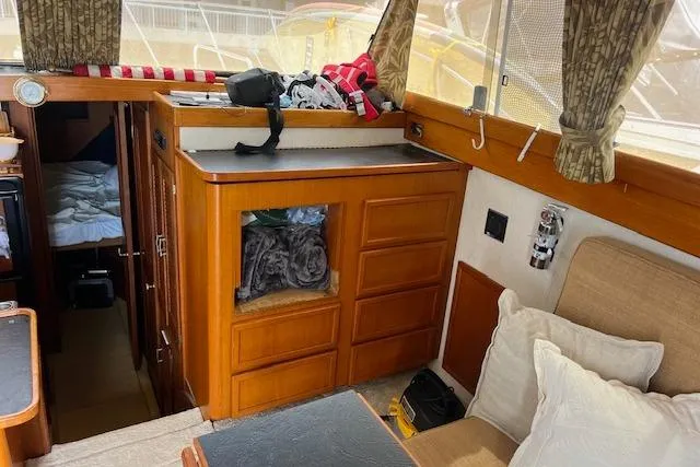 Slide: The Image of 1981 Viking 35 Convertible interior with wood cabinetry and cozy seating area. - 21