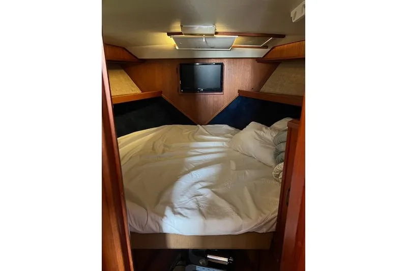 Slide: The Image of Cozy cabin interior of 1981 Viking 35 Convertible with bed and TV. - 23