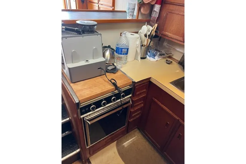 Slide: The Image of 1981 Viking 35 Convertible kitchen with stove, countertop, and wooden cabinets. - 24