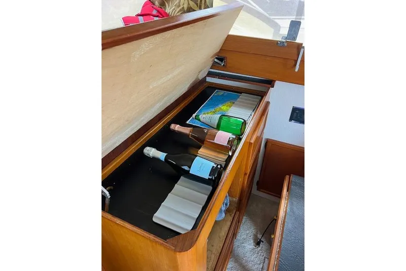 Slide: The Image of 1981 Viking 35 Convertible interior with wine storage and map. - 28