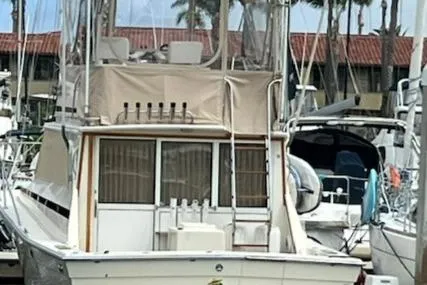 Slide: The Image of 1981 Viking 35 Convertible yacht docked, reflecting on calm water. - 3