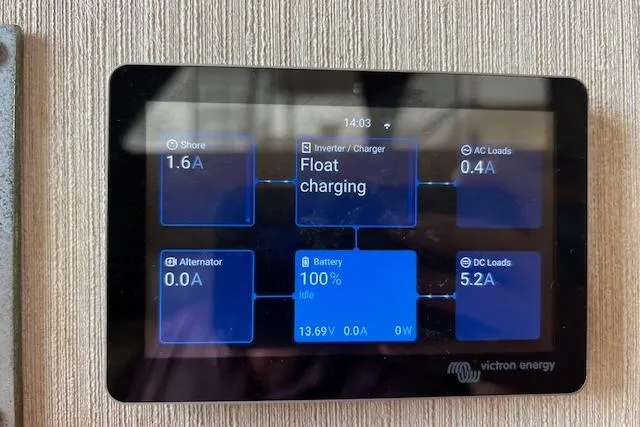 Slide: The Image of Victron Energy display showing battery status on 1981 Viking 35 Convertible boat. - 32