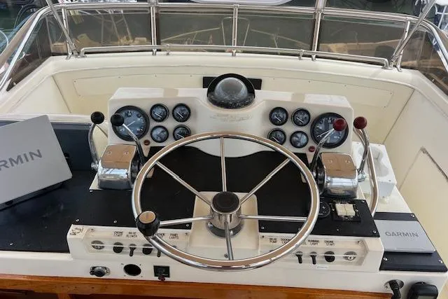 Slide: The Image of 1981 Viking 35 Convertible boat helm with Garmin navigation system and classic instrument panel. - 33