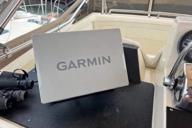 Slide: The Image of Garmin device on 1981 Viking 35 Convertible boat dashboard with binoculars. - 34