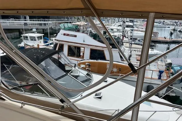 Slide: The Image of 1981 Viking 35 Convertible yacht docked in a busy marina, surrounded by other boats. - 37