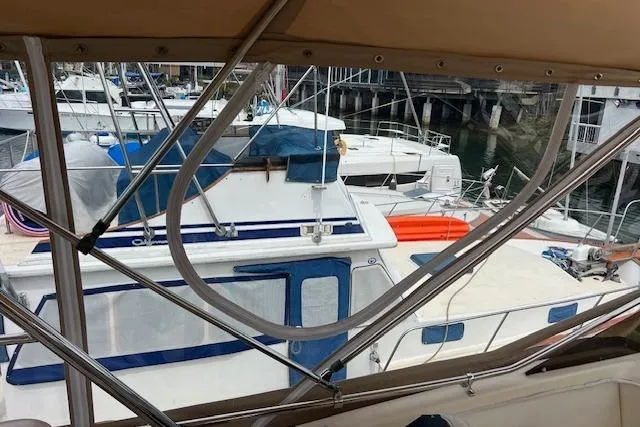 Slide: The Image of 1981 Viking 35 Convertible yacht docked in a marina, surrounded by other boats. - 38