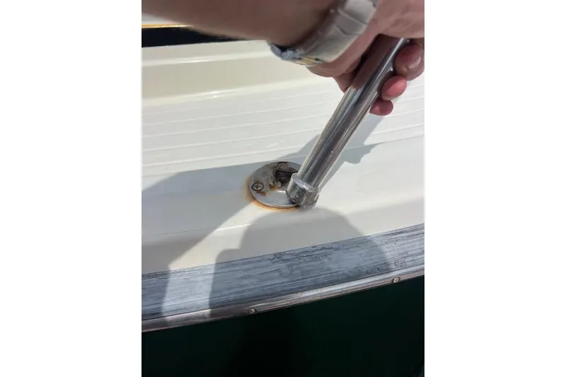 Slide: The Image of Hand adjusting railing on 1981 Viking 35 Convertible boat deck. - 6