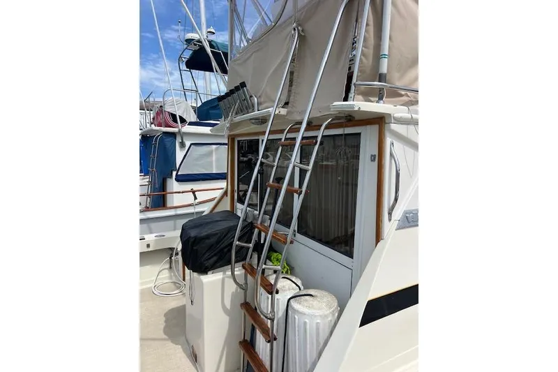 Slide: The Image of 1981 Viking 35 Convertible boat with ladder and covered equipment on deck. - 8