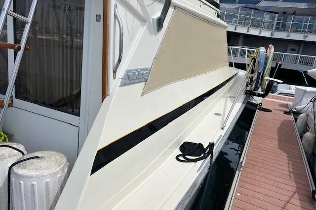 Slide: The Image of 1981 Viking 35 Convertible yacht docked, showcasing sleek design and exterior details. - 9