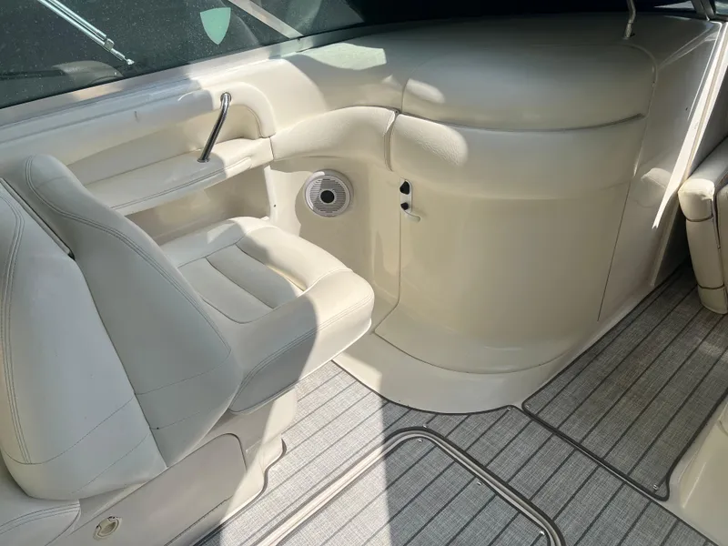 Slide: The Image of Interior of a 2000 Sea Ray 280 Bowrider with white seating and carpeted flooring. - 10