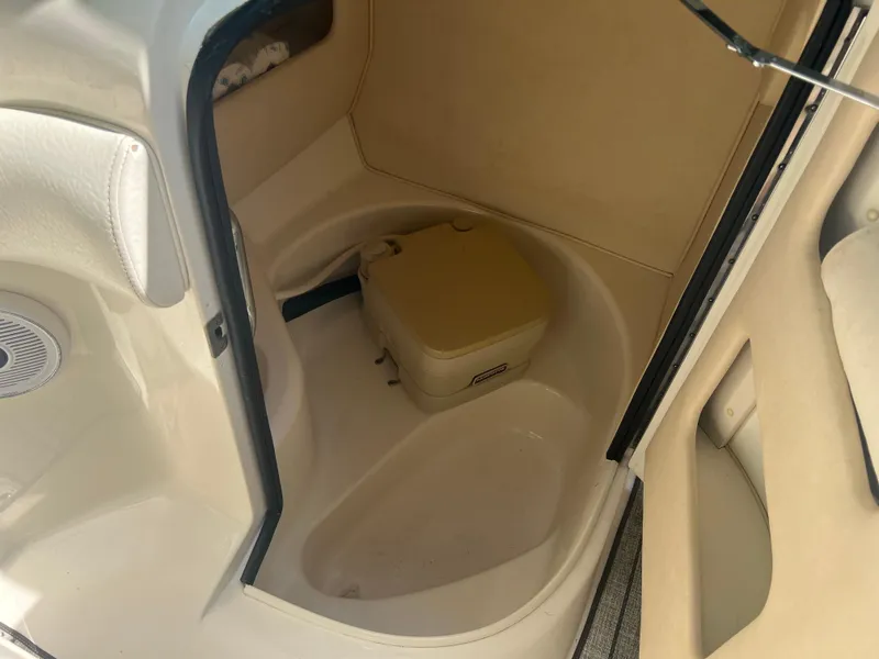 Slide: The Image of Interior of 2000 Sea Ray 280 Bowrider boat with compact toilet area. - 11