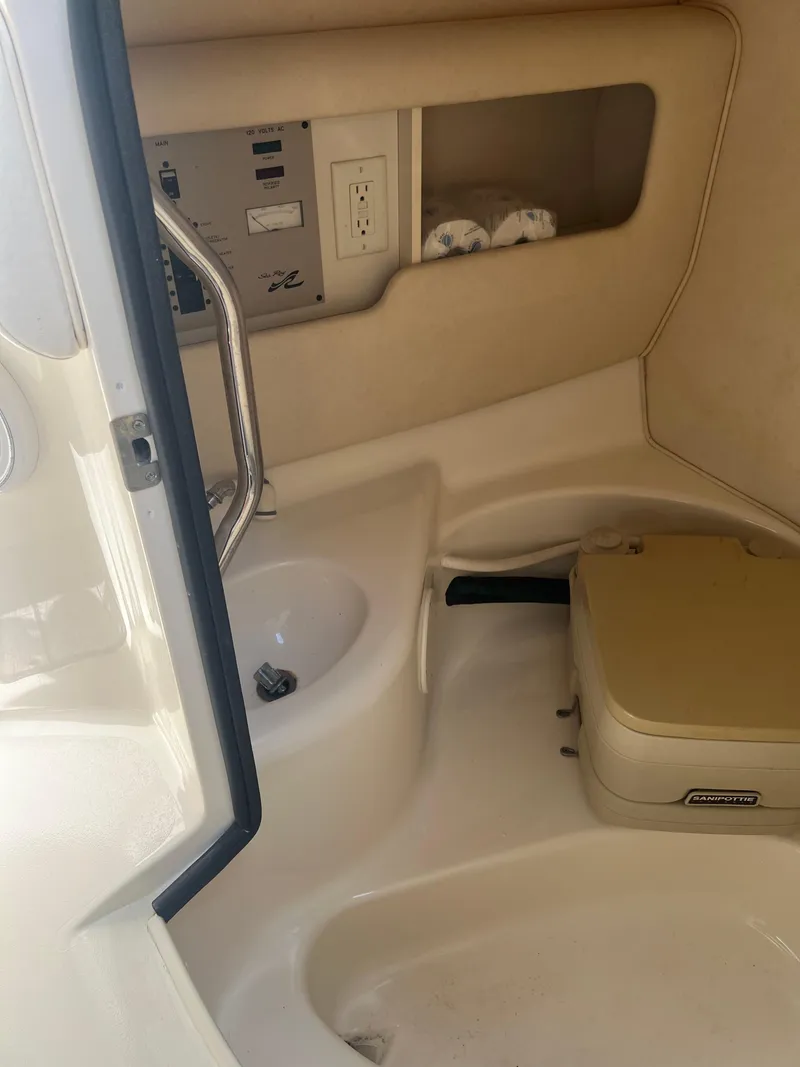 Slide: The Image of Interior of a 2000 Sea Ray 280 Bowrider boat with sink and portable toilet. - 12