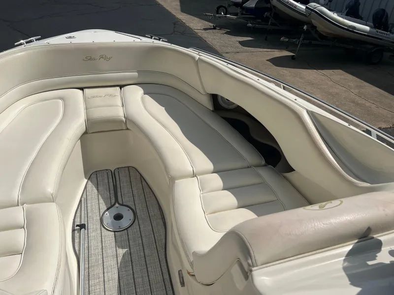 Slide: The Image of 2000 Sea Ray 280 Bowrider interior with white leather seating and wood flooring. - 15