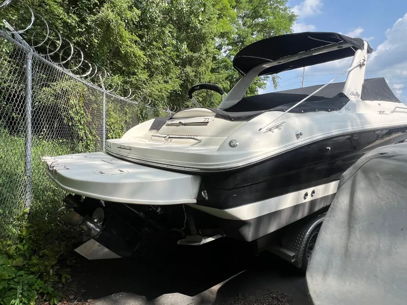 Slide: The Image of 2000 Sea Ray 280 Bowrider boat parked near a chain-link fence. - 5