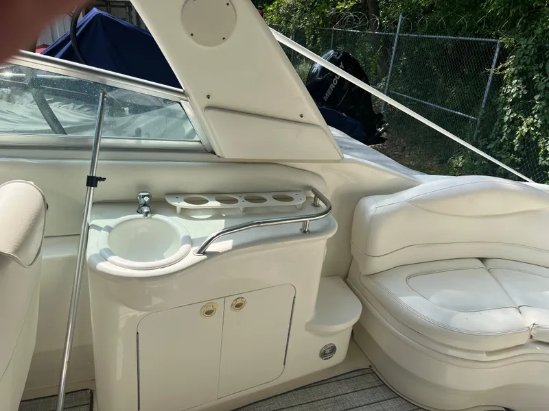 Slide: The Image of 2000 Sea Ray 280 Bowrider interior with sink and seating area. - 8