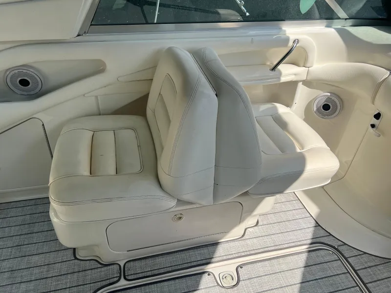 Slide: The Image of Interior seating of a 2000 Sea Ray 280 Bowrider boat, featuring white leather upholstery. - 9