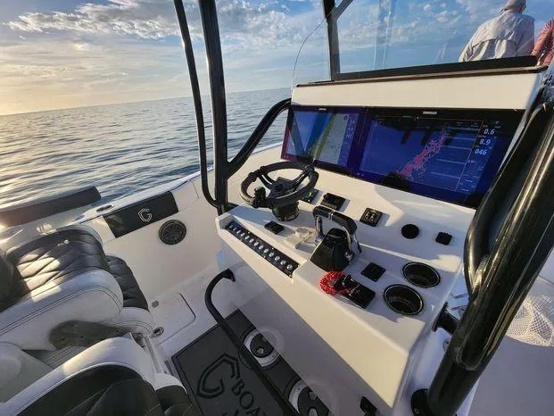 Slide: The Image of 2022 CG Boat Works 35 M-Series cockpit with modern navigation system at sea. - 11