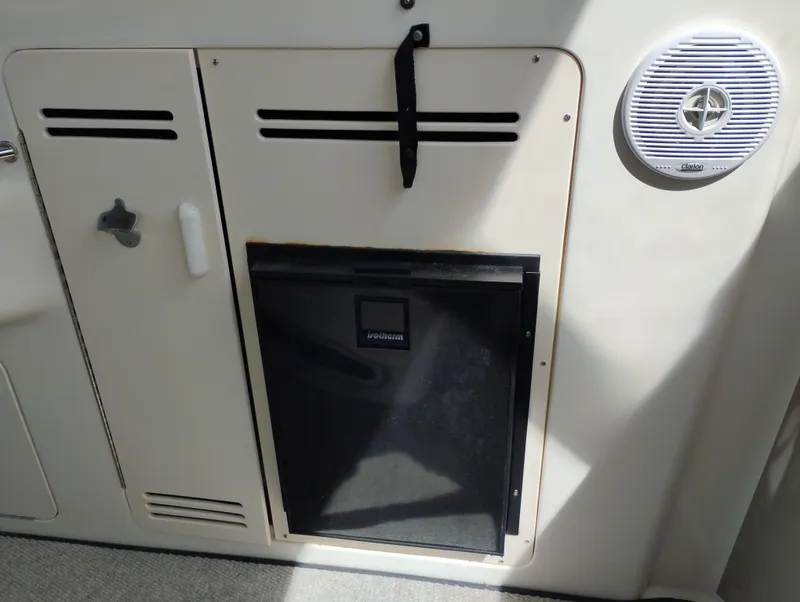 Slide: The Image of 1999 Sea Ray 400 Sundancer interior with storage compartment and Clarion speaker. - 10