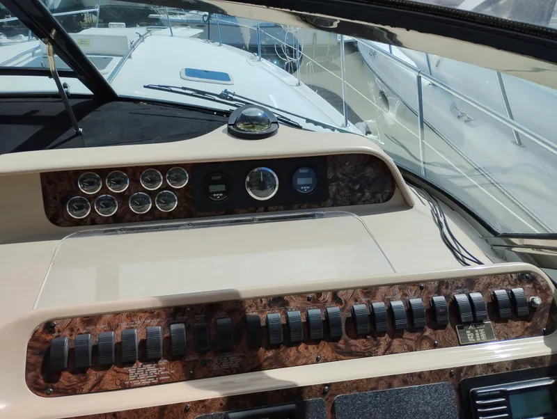 Slide: The Image of Control panel of a 1999 Sea Ray 400 Sundancer yacht with gauges and switches. - 16