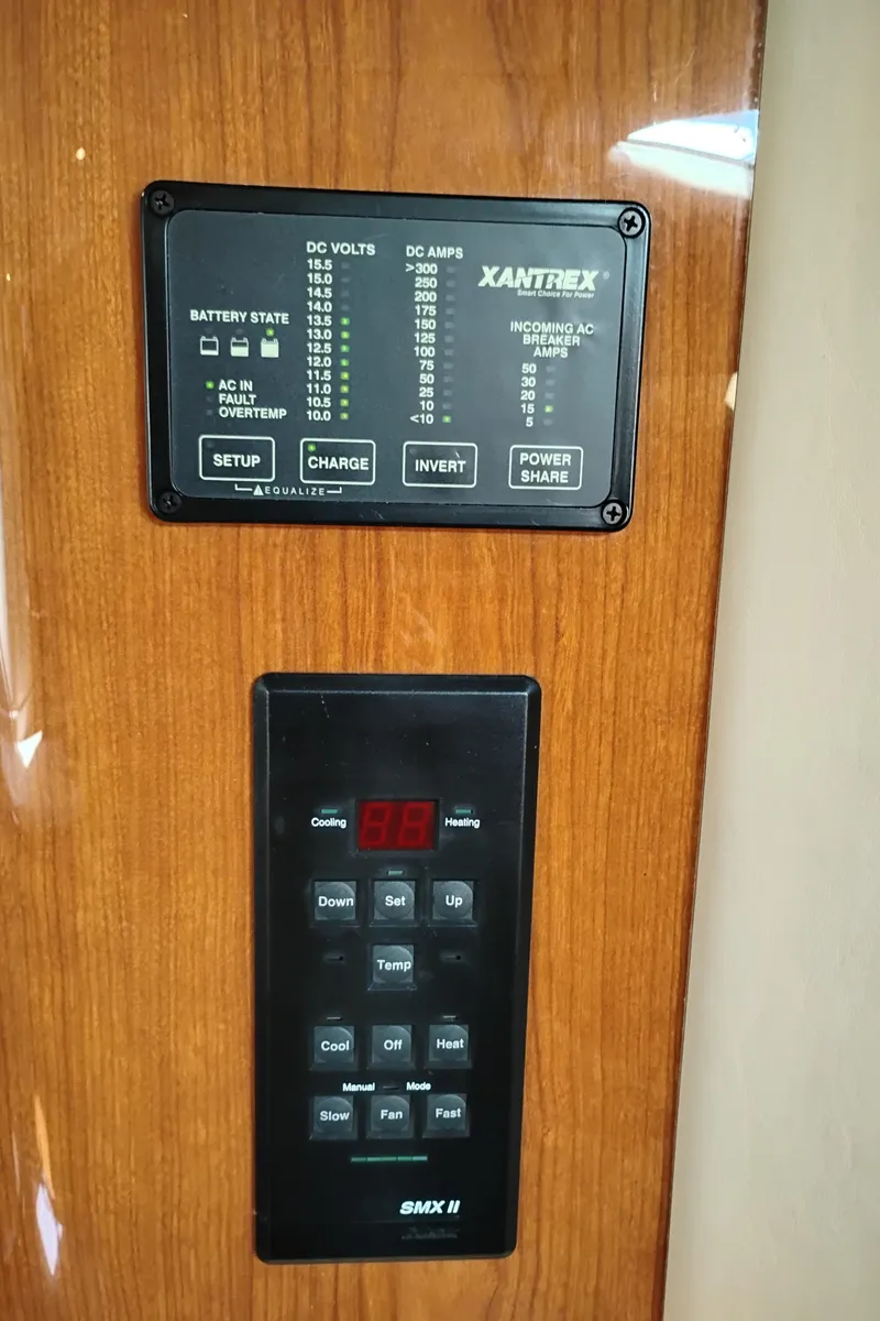Slide: The Image of Control panels on a 1999 Sea Ray 400 Sundancer yacht, featuring Xantrex and SMX II systems. - 27