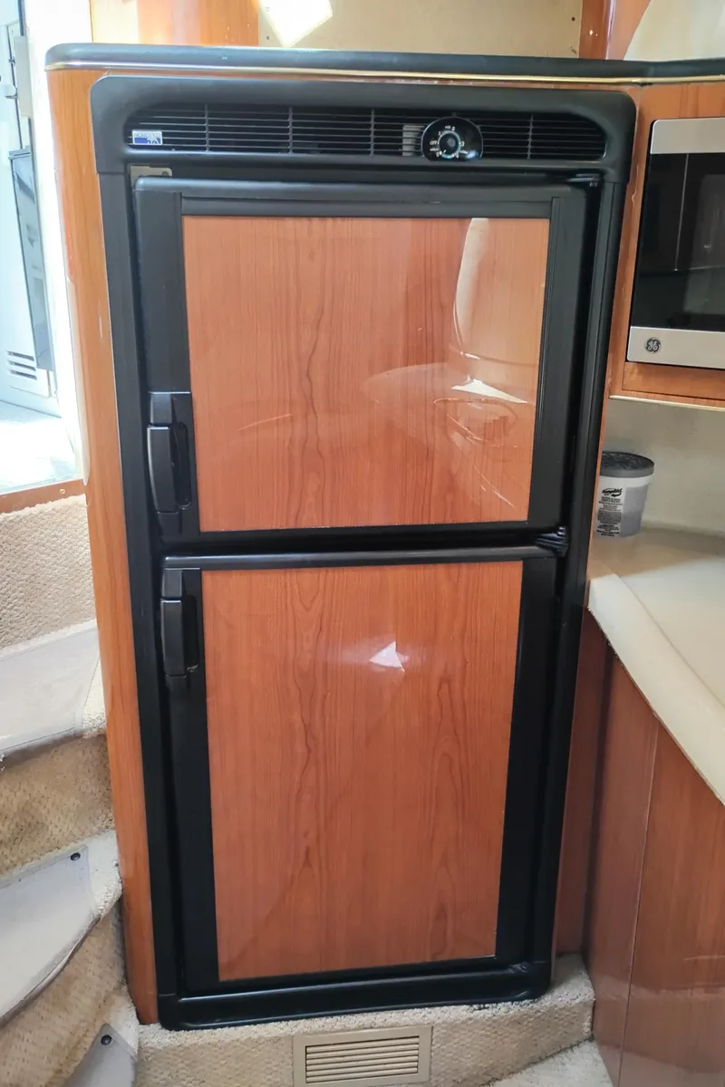 Slide: The Image of Built-in wooden refrigerator in 1999 Sea Ray 400 Sundancer yacht interior. - 31