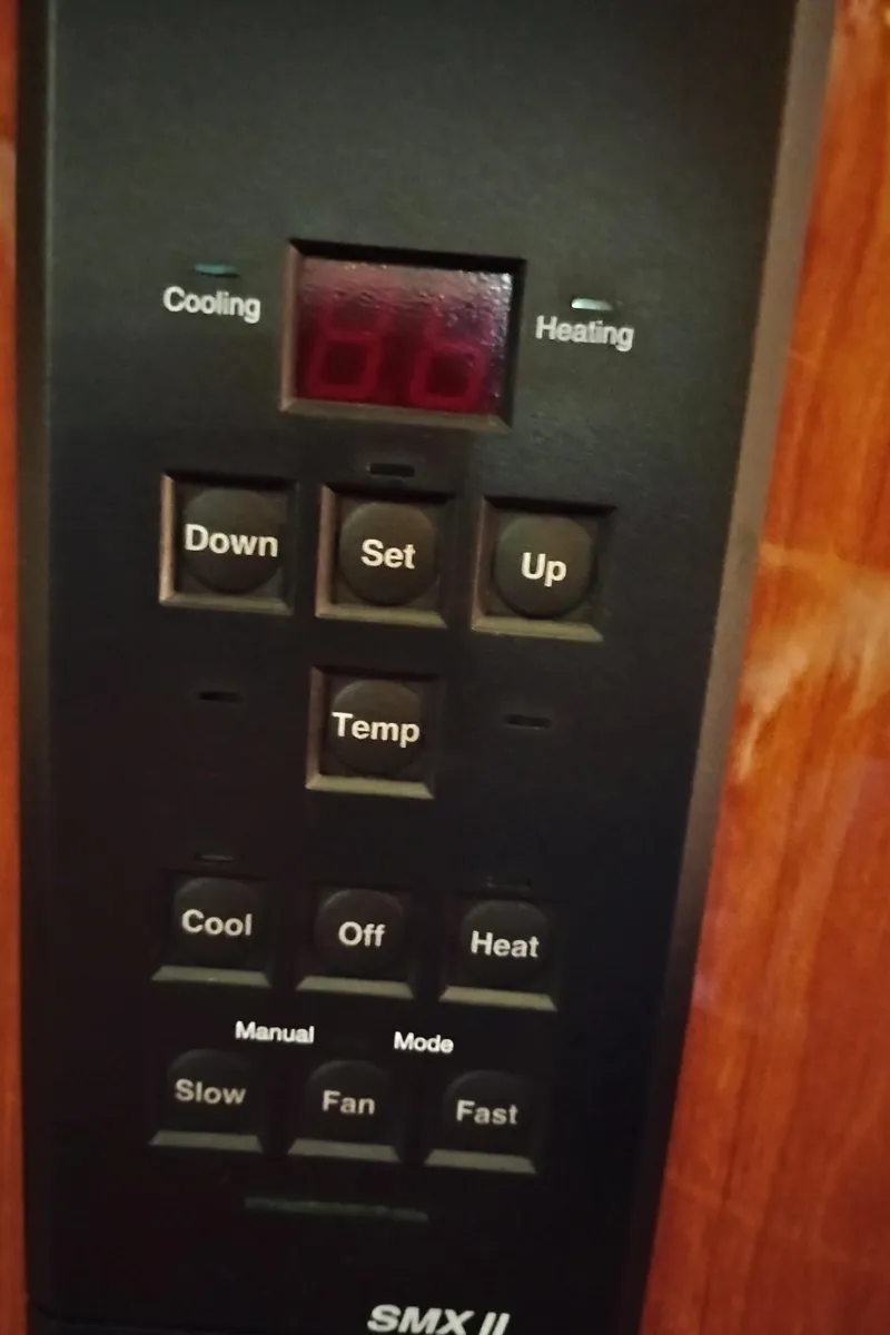 Slide: The Image of Control panel of a 1999 Sea Ray 400 Sundancer boat, featuring temperature and fan settings. - 38