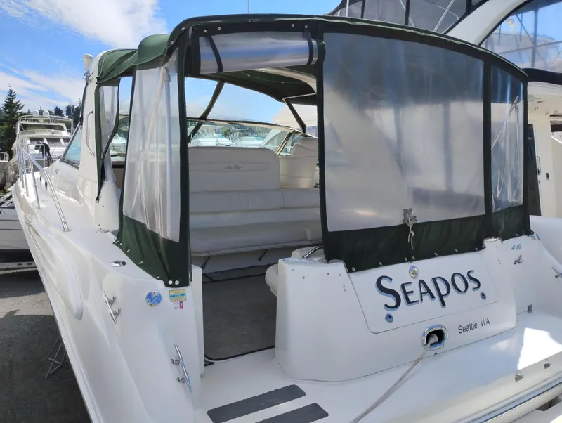 Slide: The Image of 1999 Sea Ray 400 Sundancer yacht with covered seating, docked in Seattle marina. - 4