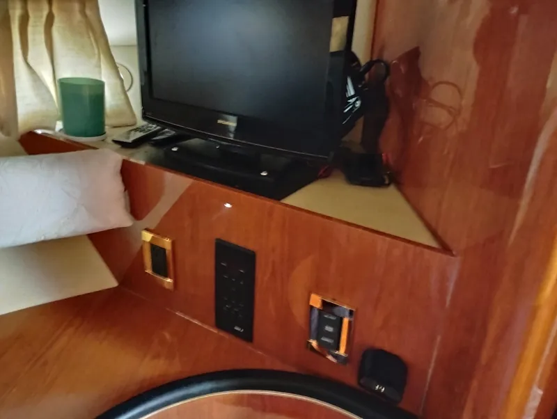 Slide: The Image of Interior of 1999 Sea Ray 400 Sundancer with TV and wooden paneling. - 40