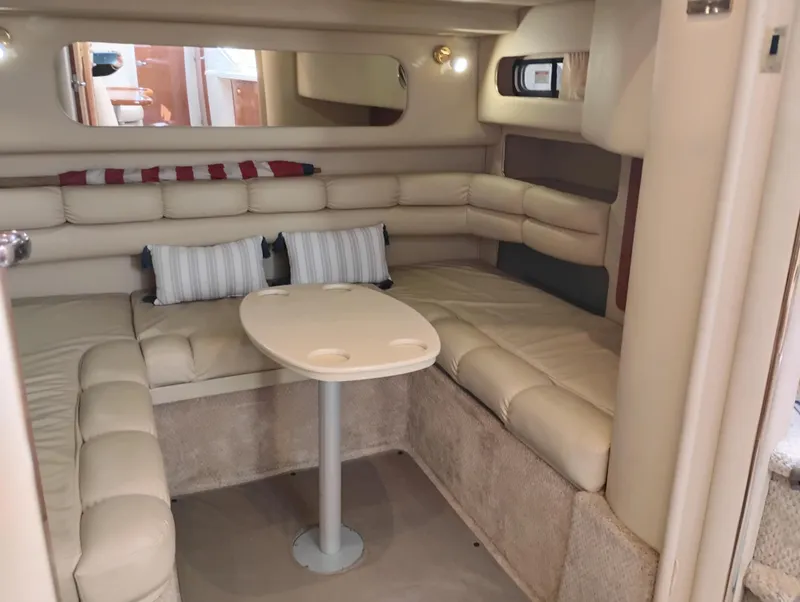 Slide: The Image of 1999 Sea Ray 400 Sundancer interior with beige seating and table. - 47