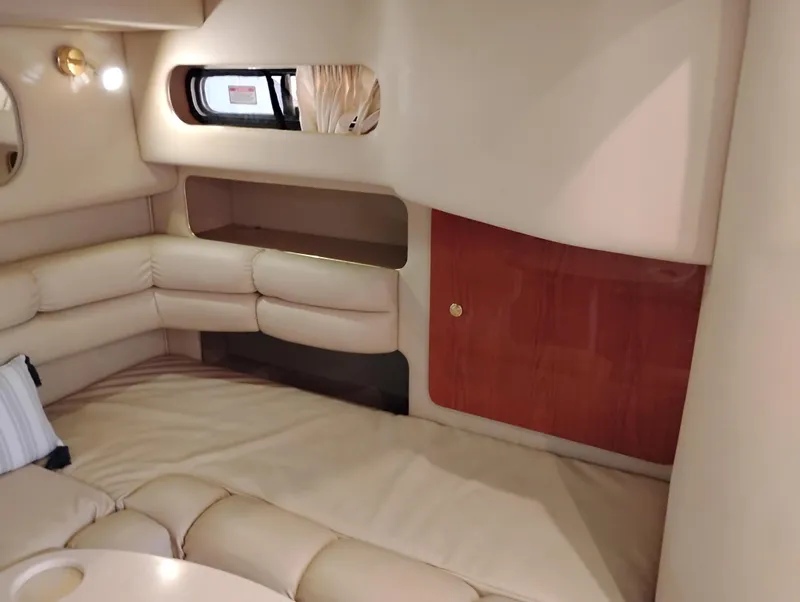 Slide: The Image of 1999 Sea Ray 400 Sundancer cabin interior with beige seating and wooden accents. - 48