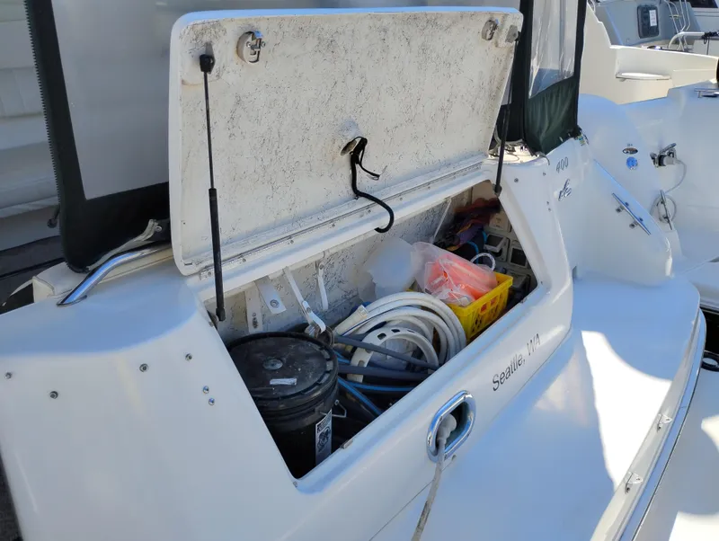 Slide: The Image of 1999 Sea Ray 400 Sundancer storage compartment with boating equipment and supplies. - 5
