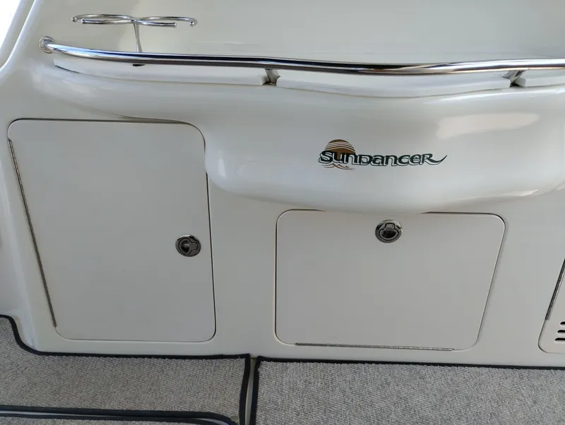 Slide: The Image of 1999 Sea Ray 400 Sundancer boat with storage compartments and Sundancer logo. - 9