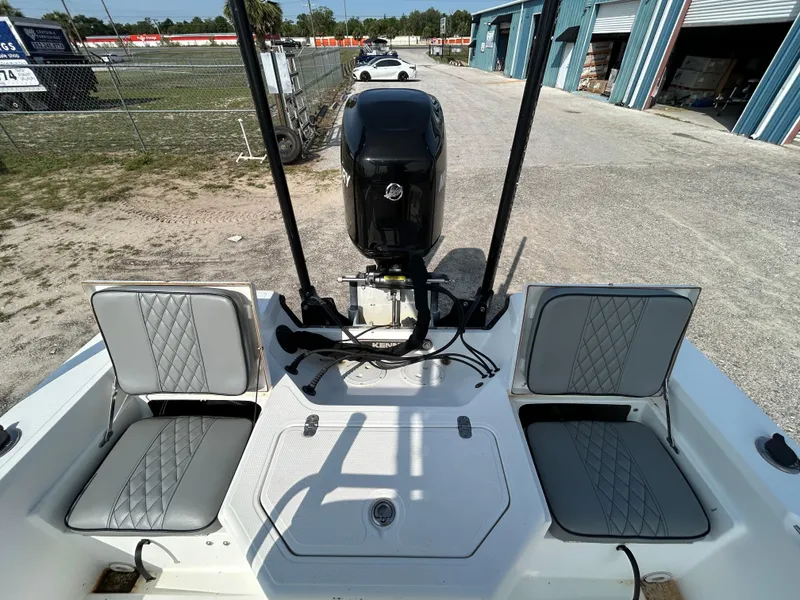 Slide: The Image of Kenner Vision 2103 boat, 2008 model, with dual seats and outboard motor in a storage area. - 12