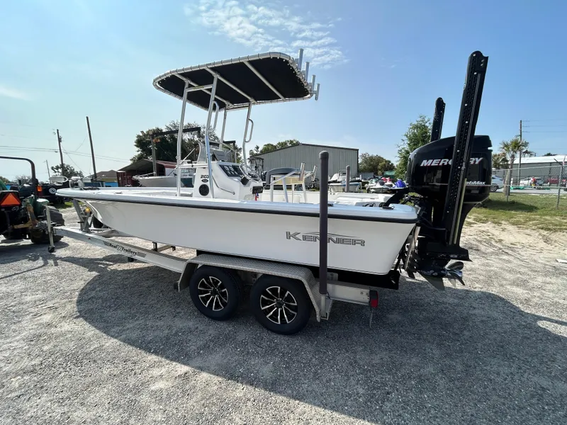 Slide: The Image of 2008 Kenner Vision 2103 boat on trailer with Mercury engine, parked outdoors. - 4