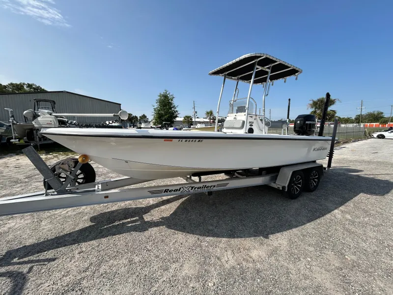 Slide: The Image of 2008 Kenner Vision 2103 boat on trailer under clear blue sky. - 5